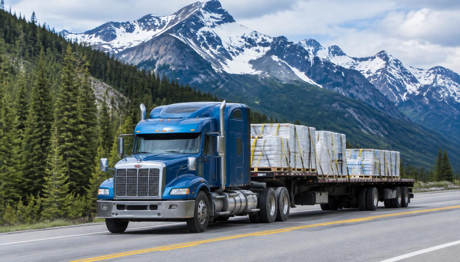 Flat deck trailer hauling commercial freight between Vancouver, BC and Calgary, Alberta